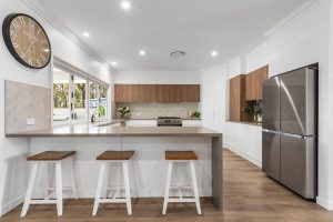 Modern contemporary house exterior with warm lighting and landscaped front yard.