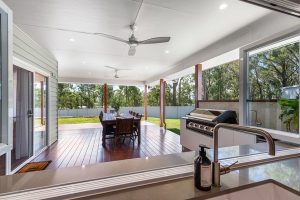 Modern contemporary home exterior with warm entry lighting and landscaped driveway.