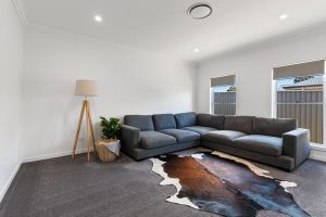 Modern contemporary home exterior with warm lighting and landscaped front yard.